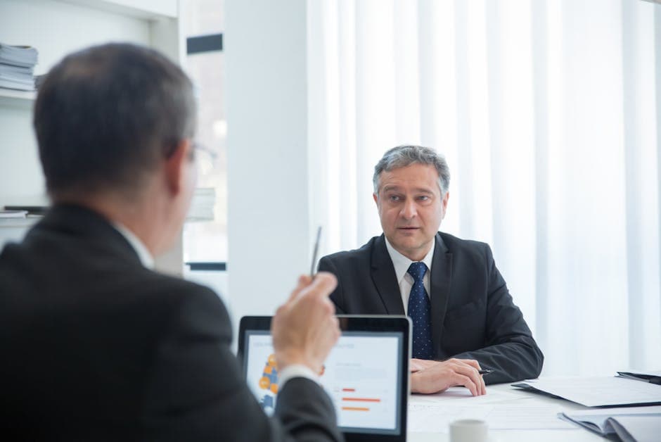 Business professionals in a focused discussion during an office meeting.