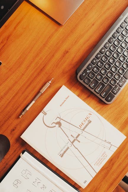 Organized workspace featuring a notebook, keyboard, and office supplies.