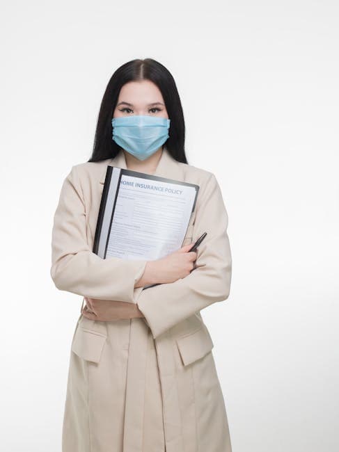 Portrait of a woman holding an insurance policy folder while wearing a mask, set against a white background.