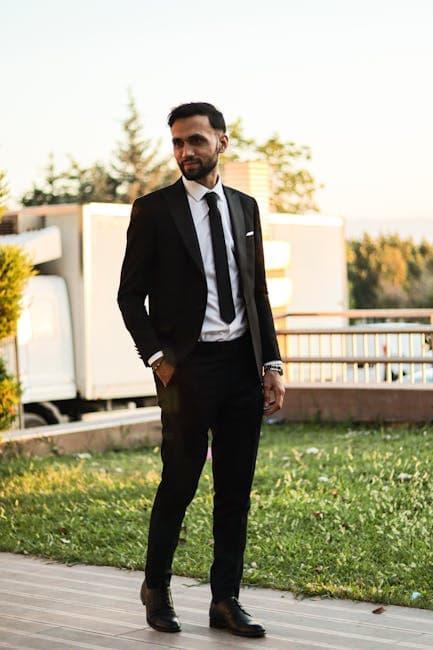 Stylish man in suit outdoors exuding confidence and professionalism.