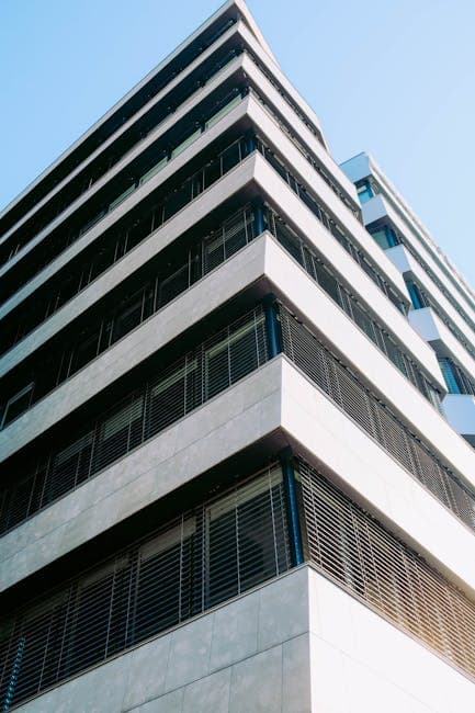 Low angle view of a contemporary urban office building showcasing modern architectural design.
