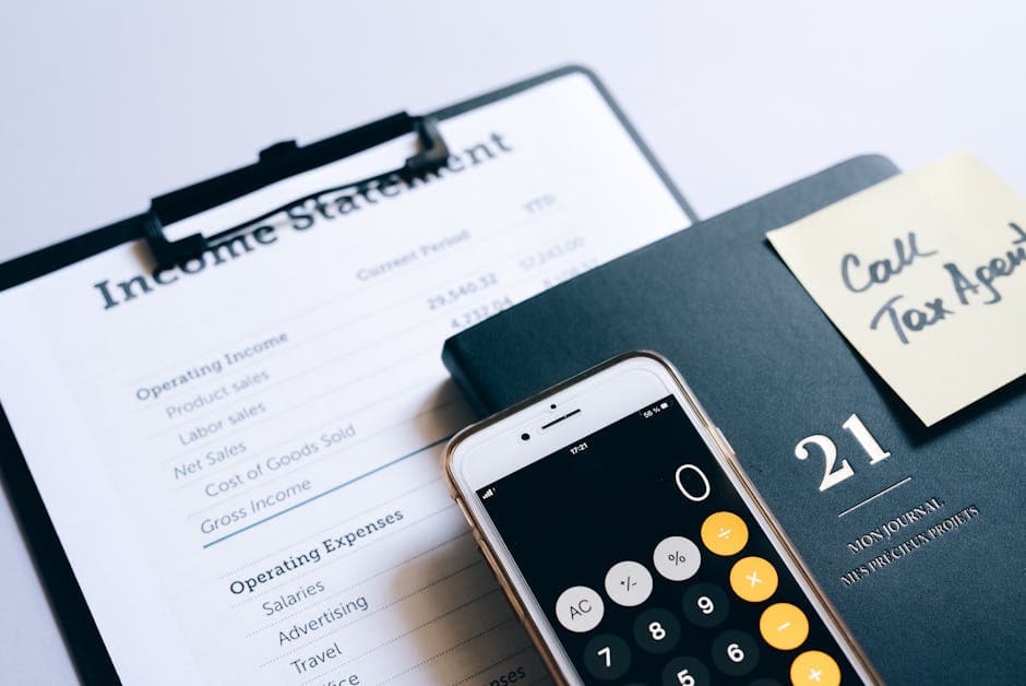 Close-up of income statement, calculator, and planner for financial planning.